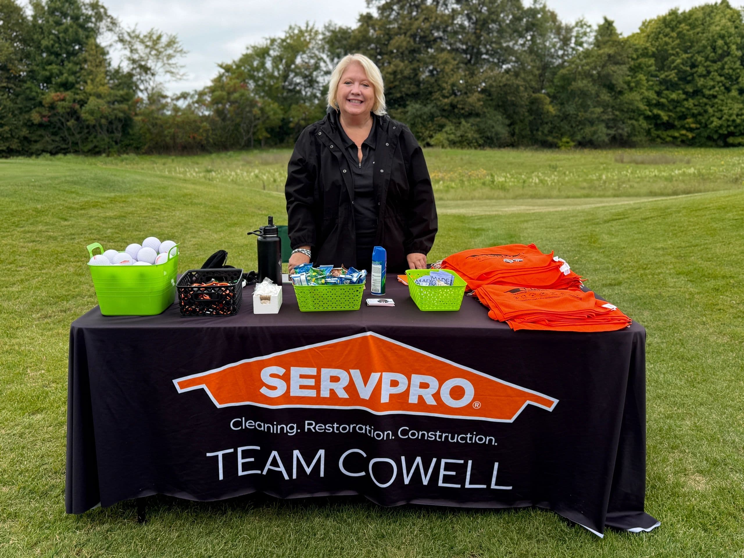 A sponsor table on the course at the SEWI Claims Golf Outing